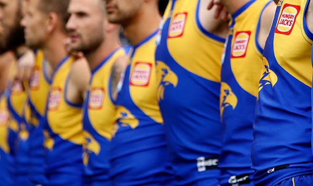 AFL 2018 Toyota AFL Grand Final - West Coast v Collingwood MELBOURNE, AUSTRALIA - SEPTEMBER 29: Adam Simpson, Senior Coach of the Eagles lines up with players for the national anthem during the 2018 Toyota AFL Grand Final match between the West Coast Eagles and the Collingwood Magpies at the Melbourne Cricket Ground on September 29, 2018 in Melbourne, Australia. (Photo by Adam Trafford/AFL Media)